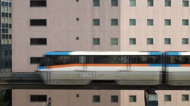 Monorail riding through urban landscape — Stock Video