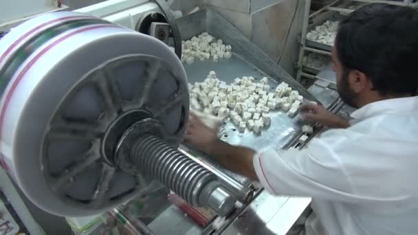 Man sorts pieces of nougat — Stock Video