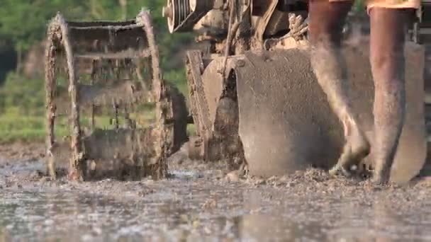 An Indian farmer ploughing his land with a machine — Stock Video