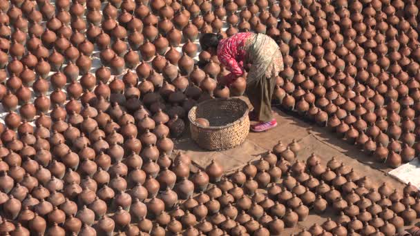 Woman lays pots to dry in the sun — Stock Video