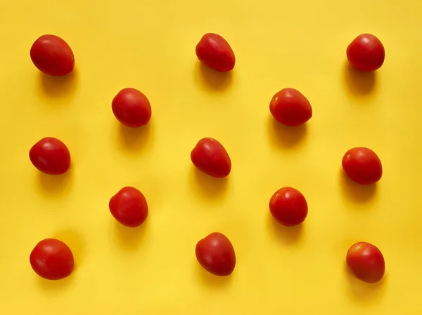 Tomatoes dots on yellow background — Stock Photo, Image