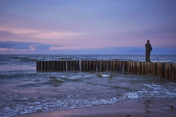 Puesta de sol pescando en rompeolas —  Fotos de Stock