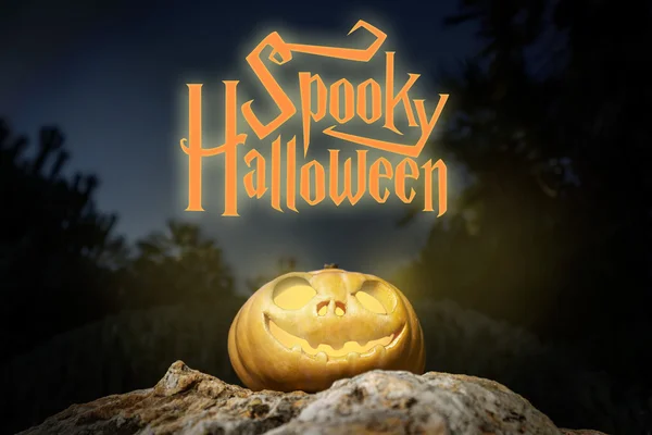 Spooky Halloween warm neon pumpkin in on a rock in the darkness — Stock Photo, Image