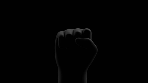 Black fist on black background with rim. Front view. Black Lives Matter. Blackout. Social justice concept. 3D render. 
