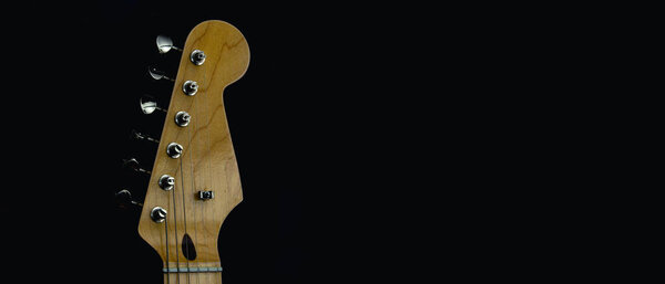 Top of the neck of an electric guitar. Selective focus. Copy space.
