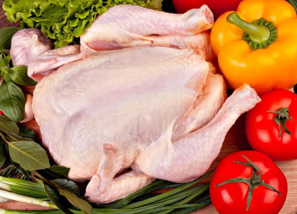 Fresh raw chicken and vegetables prepared for cooking