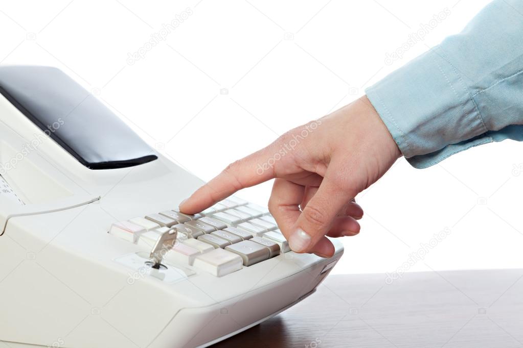 Sales person entering amount on cash register in retail store 