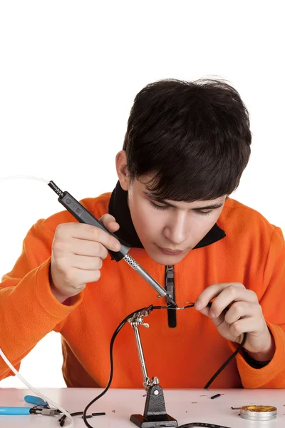 A boy learning to solder wires — Stock Photo, Image