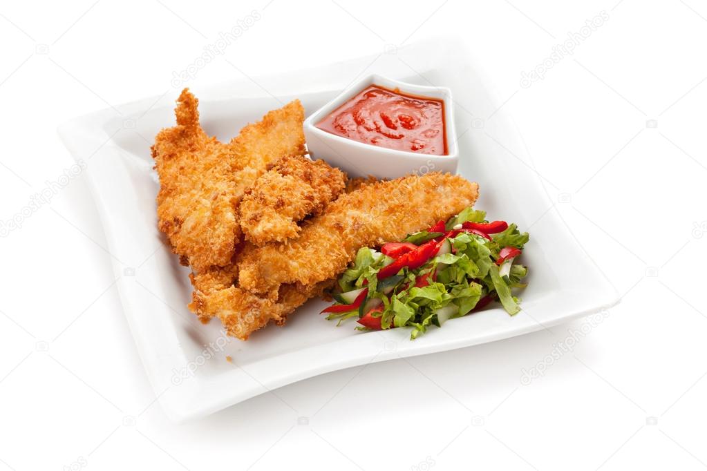 Fried chicken breast fillet in batter with vegetable salad on th