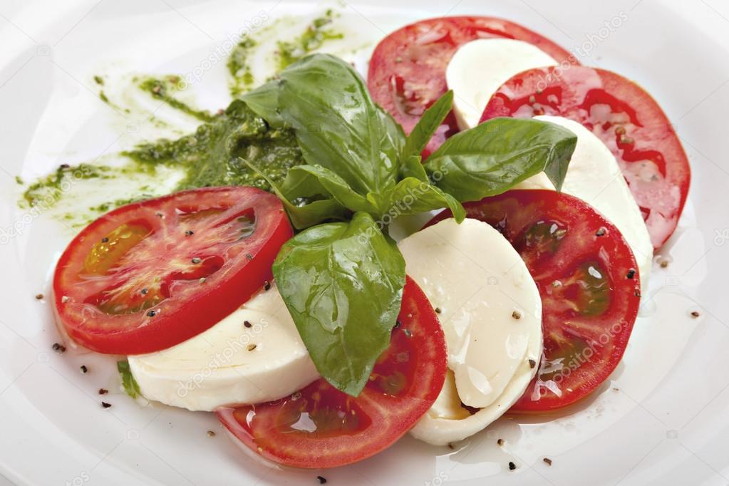 Caprese - italian salad with mozzarella cheese, tomato and basil