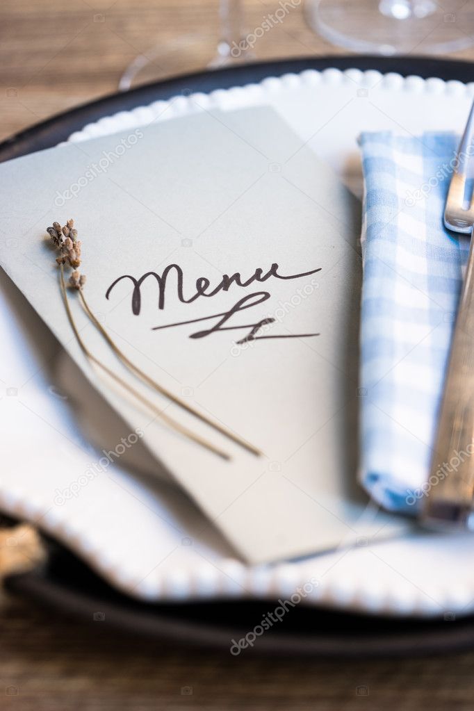 Restaurant table setting with menu and utensils