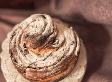 Geleneksel kek Paskalya pastası keki. Koyu ahşap arka planda kuru üzümlü kek. Şekerli meyveli ev yapımı kek Cruffin. Doğal olarak mermer taşlı amber çiçeğiyle boyanmış yumurtalar..