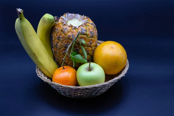 Taze meyve, muz, elma, ananas, portakal dolu sepetler.