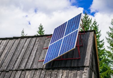 A solar panel in a remote mountain village clipart