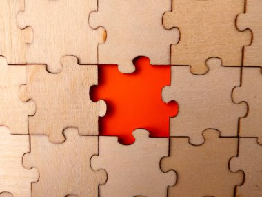 This image shows a wooden jigsaw puzzle with a single missing piece.
