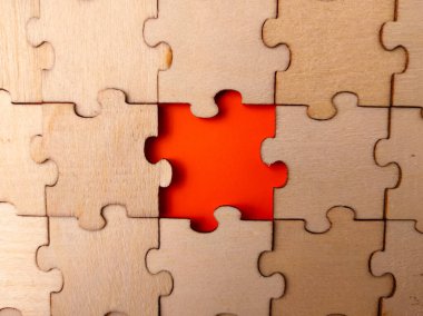 This image shows a wooden jigsaw puzzle with a single missing piece.