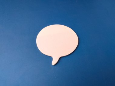 The image features a single, light pink speech or chat bubble set against a solid blue background.