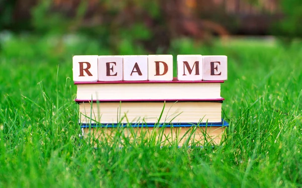 Book stack with read me sign on the top