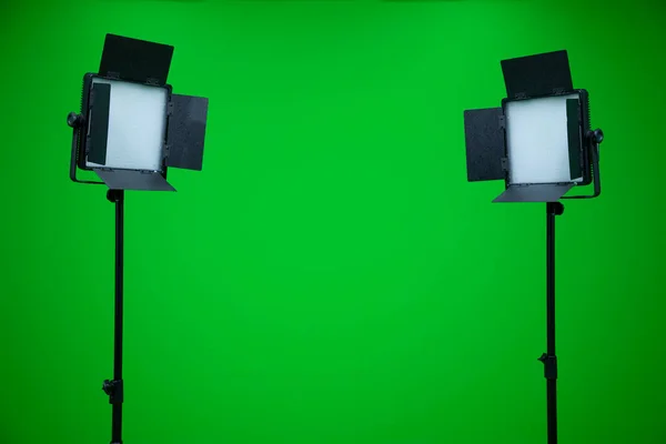 Green screen television studio with two fill lights. Lights are turn off in chroma studio