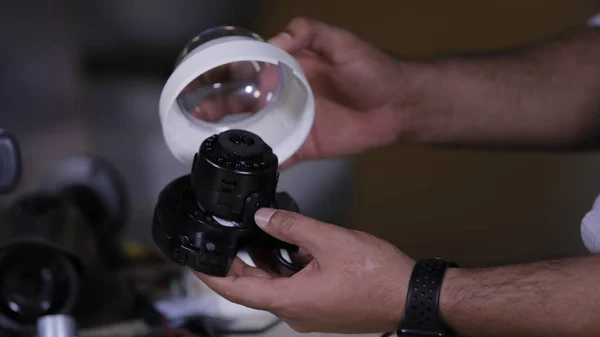 A man repairing secur camera in service center
