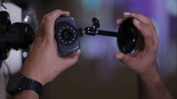 l closeup of a male technician's hand repairing a CCTV camera in the service center