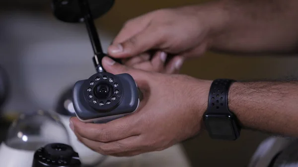 A man repairing security camera in service center