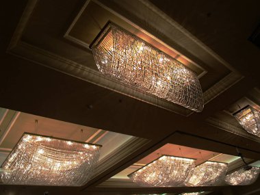 Bastırılmış ışıkta cam kolyelerden yapılmış lüks avizeler.