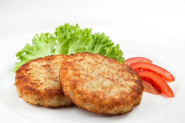 Pork cutlet with green salad and tomato isolated on white background. Chicken cutlet with green salad