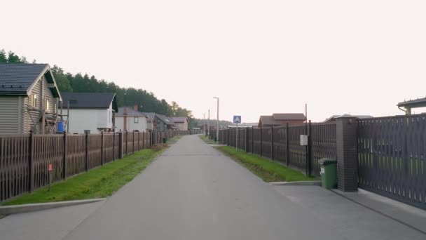 A view at the cottage village areas and infrastructure, roads, houses, dense forest and the countryside landscape on the warm summer day — Stock videók