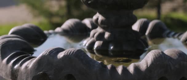 Primer plano sobre el agua tranquila y constante en la fuente ociosa en el campo en verano en un pueblo de campo, parque y área de recreación en un día caluroso, reflejos en el agua — Vídeos de Stock