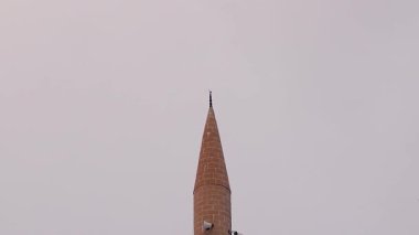 Kar yağışı sırasında uçan ve caminin minaresine inen Kapüşonlu Karganın Sinematik Çekimi, kış değişikliğini, maneviyatı ve vahşi yaşamı sembolize ediyor. Kültürel, dini, hava durumu ve belgesel için ideal