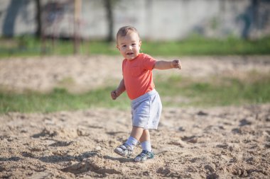 Little  boy walking on the sand