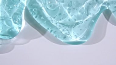 Yavaşça kayan mikro baloncuklu şeffaf sıvı jel kremi. Makro Vuruş