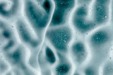 Sıvı krem jöle, köpüklü yeşil mavi kozmetik doku.