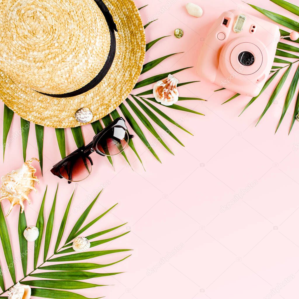 Womans beach accessories: bikini, rattan bag, straw hat, tropical palm leaves on yellow background. Summer background. 