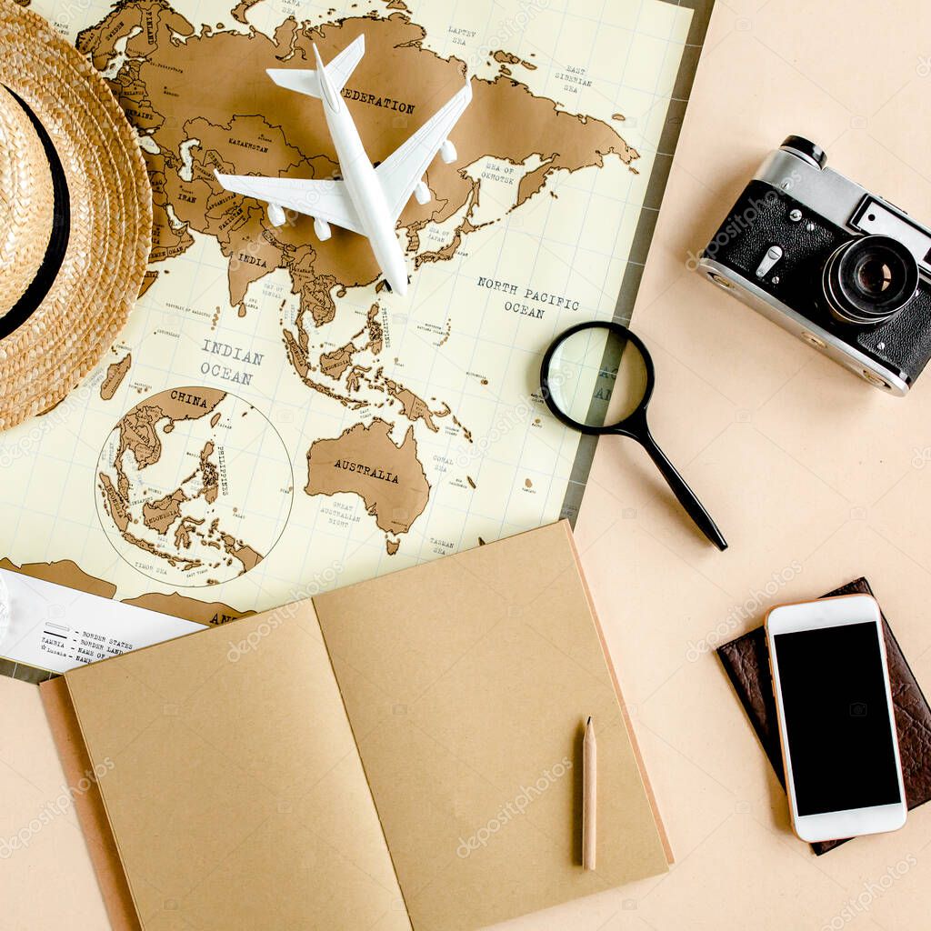 Planning vacation, travel plan, trip vacation using world map along with other travel accessories. Top view, flat lay. 