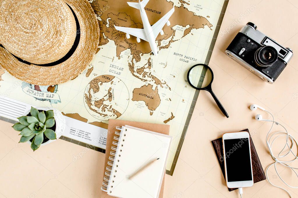 Planning vacation, travel plan, trip vacation using world map along with other travel accessories. Top view, flat lay. 