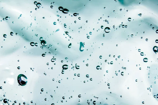Gel líquido crema, textura cosmética azul verde con burbujas —  Fotos de Stock