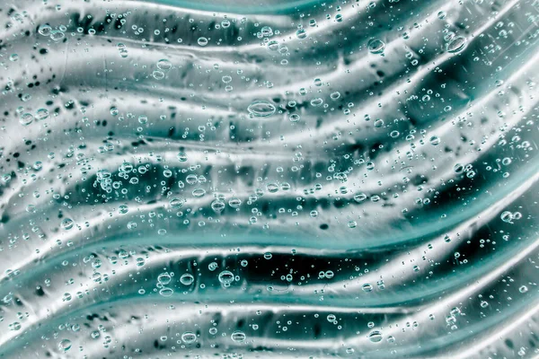 Gel líquido crema, textura cosmética azul verde con burbujas — Foto de Stock