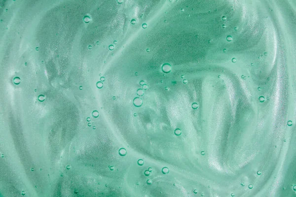 Gel crème liquide, texture cosmétique bleue verte avec bulles — Photo