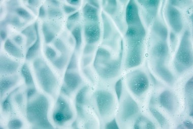 Sıvı krem jöle, köpüklü yeşil mavi kozmetik doku.