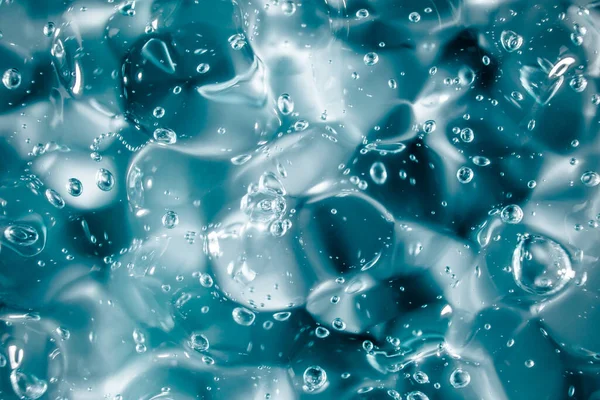 Gel crème liquide, texture cosmétique bleue verte avec bulles — Photo