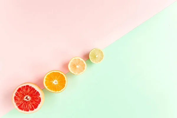 Board frame and summer tropical fruits: orange, lemon, lime, mango on pink background. Food concept. flat lay, top view — Stock Photo, Image