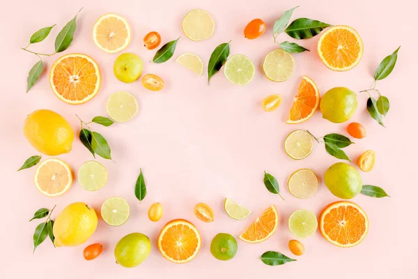 Frame made of summer tropical fruits: orange, lemon, lime, mango on pink background. Food concept. flat lay, top view — Stock Photo, Image