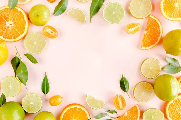 Frame made of summer tropical fruits: orange, lemon, lime, mango on pink background. Food concept. flat lay, top view — Stock Photo, Image