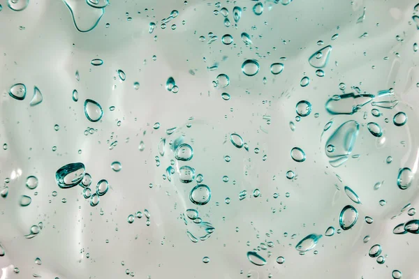 Gel crème liquide, texture cosmétique bleue verte avec bulles — Photo