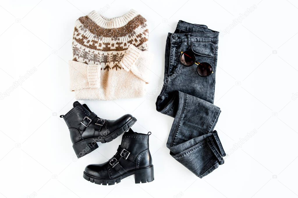 Women fashion clothes and accessories. Feminine youth collage top view. Flat lay female style look with warm sweater, jeans, boot. Top view.