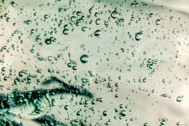 Sıvı krem jöle, köpüklü yeşil mavi kozmetik doku.