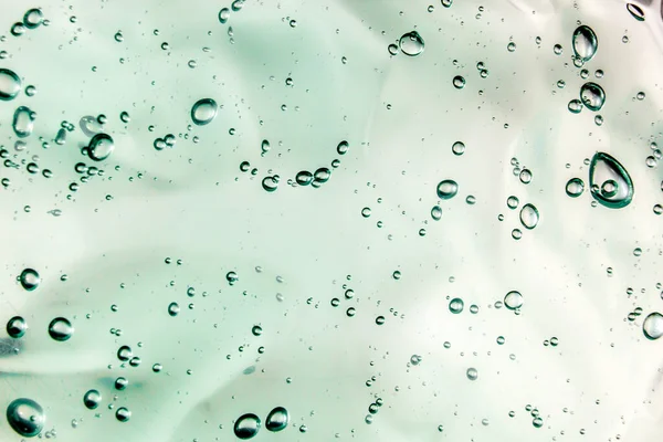 Sıvı krem jöle, köpüklü yeşil mavi kozmetik doku.