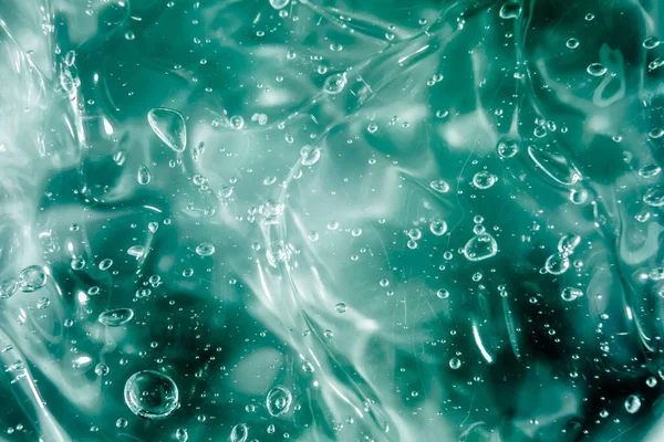 Sıvı krem jöle, köpüklü yeşil mavi kozmetik doku.